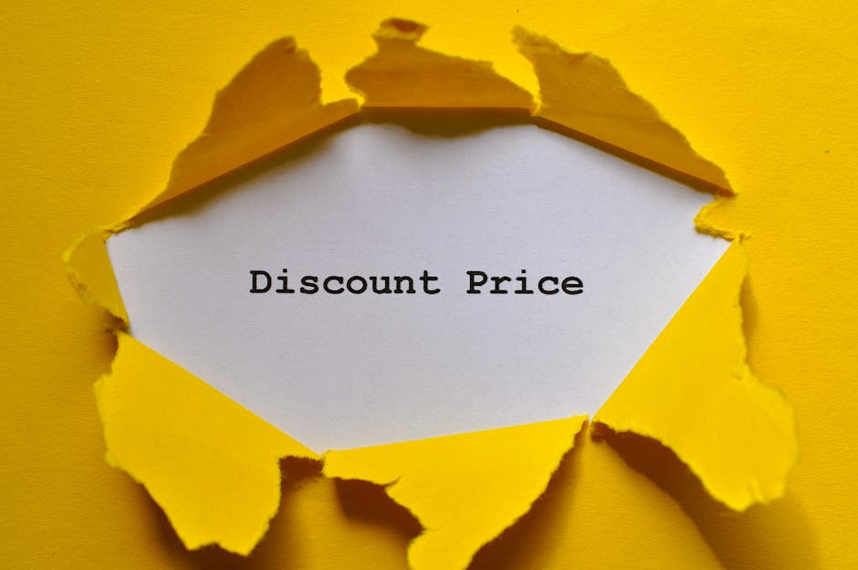 A close-up of a torn yellow paper revealing a white inner layer with the text 'Discount Price' typed in black. The torn edges are rough and uneven, exposing the message beneath. The background surrounding the torn paper is also yellow, creating a vibrant contrast that highlights the message. This image suggests savings or special offers related to cleaning services provided by Carpet Cleaning Sidcup, emphasizing affordable and transparent pricing for surface and deep cleaning tasks within residential or commercial spaces.